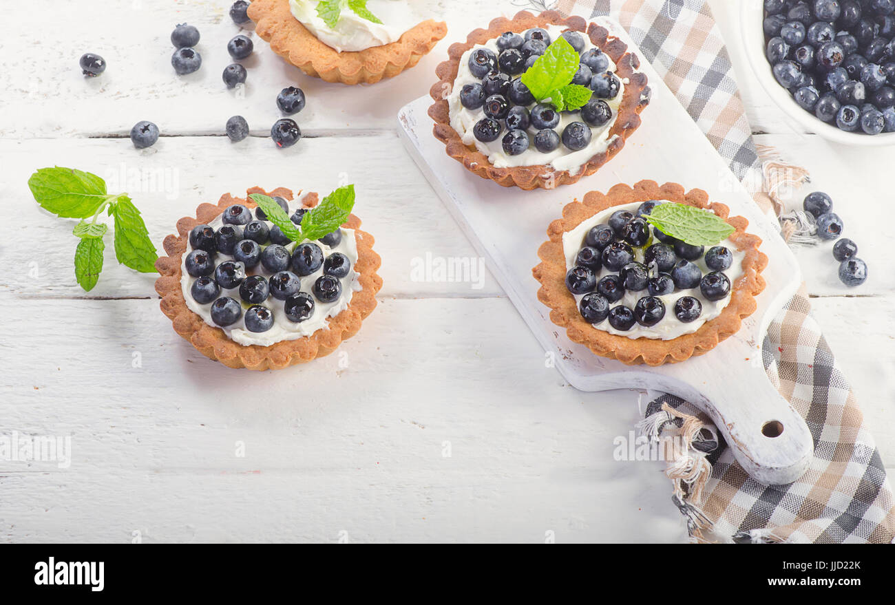 Blueberry tarts on white wooden table. View from above Stock Photo