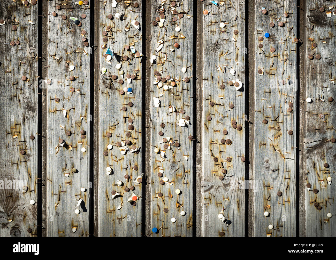 Wooden wall with old pins and staples. Vintage bulletin board Stock
