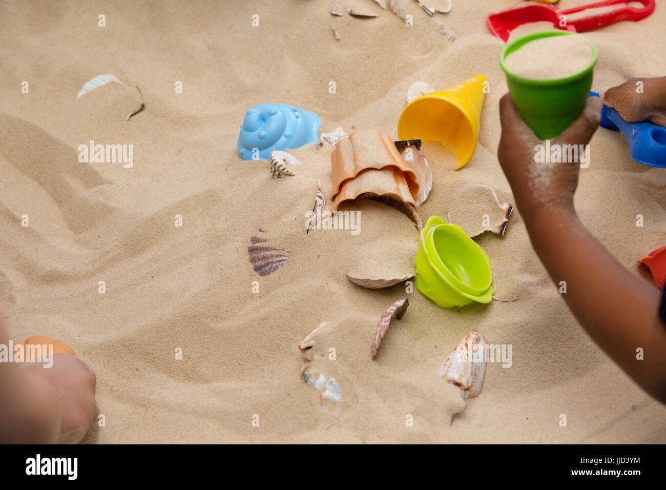 Little Hands Exploring The Beach Sand Stock Photo