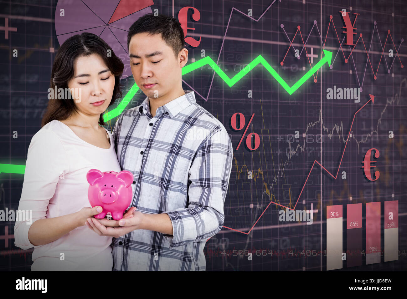 Couple holding their piggy bank against red arrow Stock Photo - Alamy