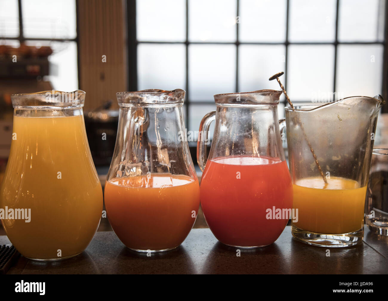 Jugs of fruit juice on a table Stock Photo Alamy