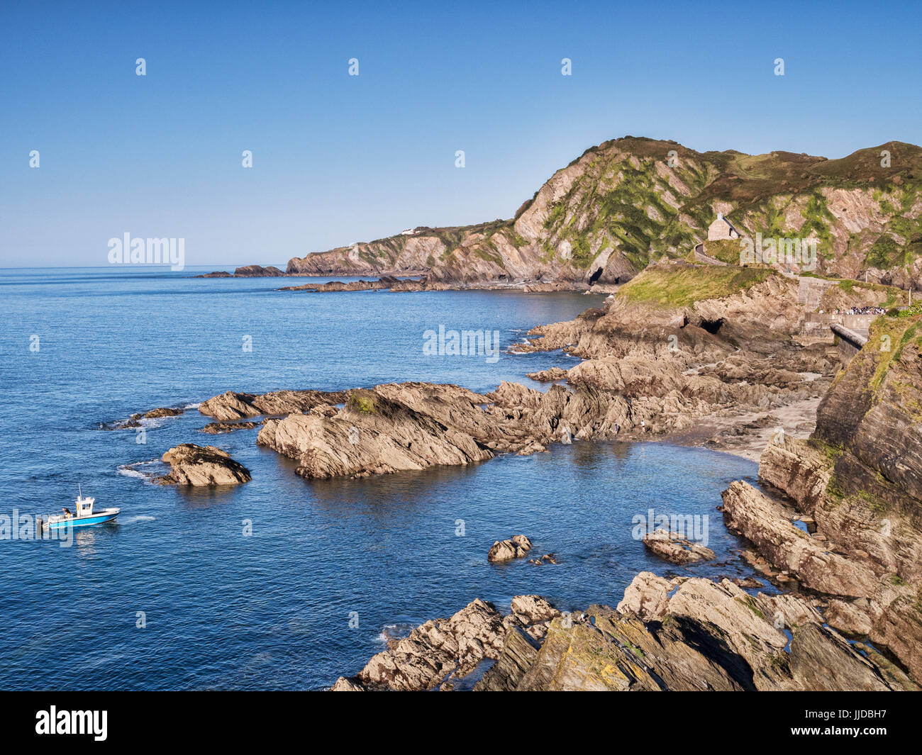 17 June 2017: Ilfracombe, North Devon, England, UK - Ilfracombe from Capstone Hill, with Lantern Hill and Hillsborough Hill, and a boat making its way Stock Photo
