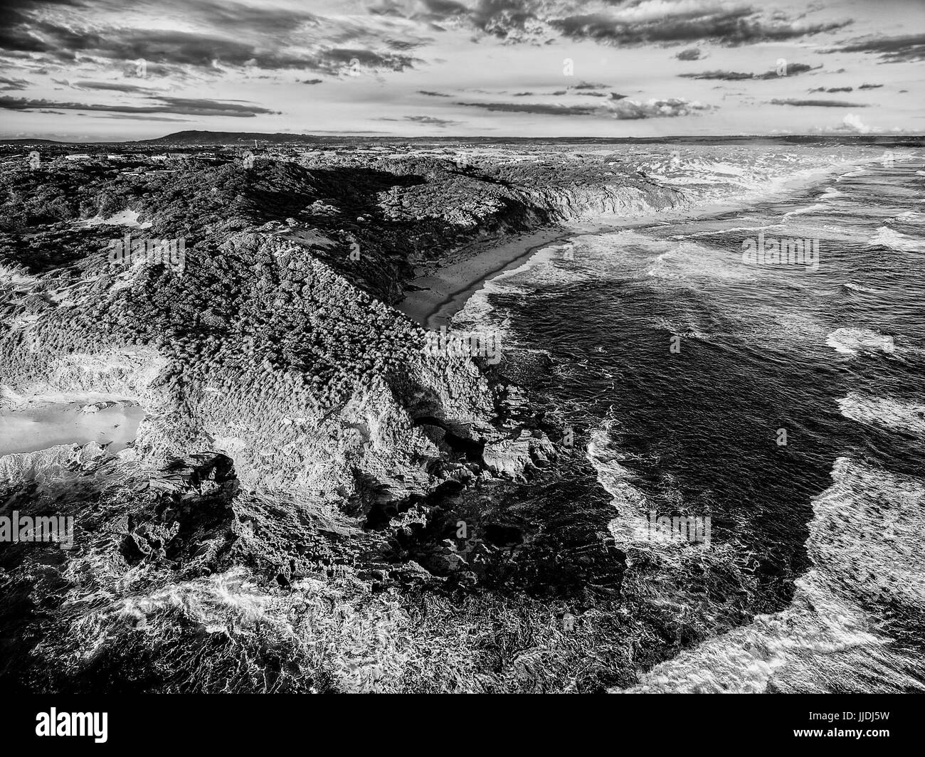 Aerial view of rugged coastline stylized in black and white with high contrast Stock Photo