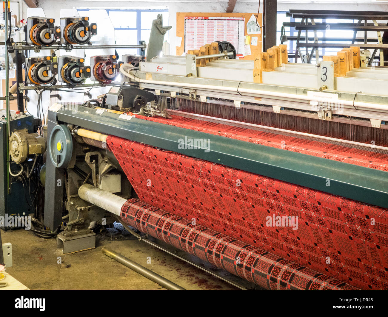 Fabric being woven on a loom at the Melyn Tregwynt Mill in Pembrokeshire, Wales, UK Stock Photo