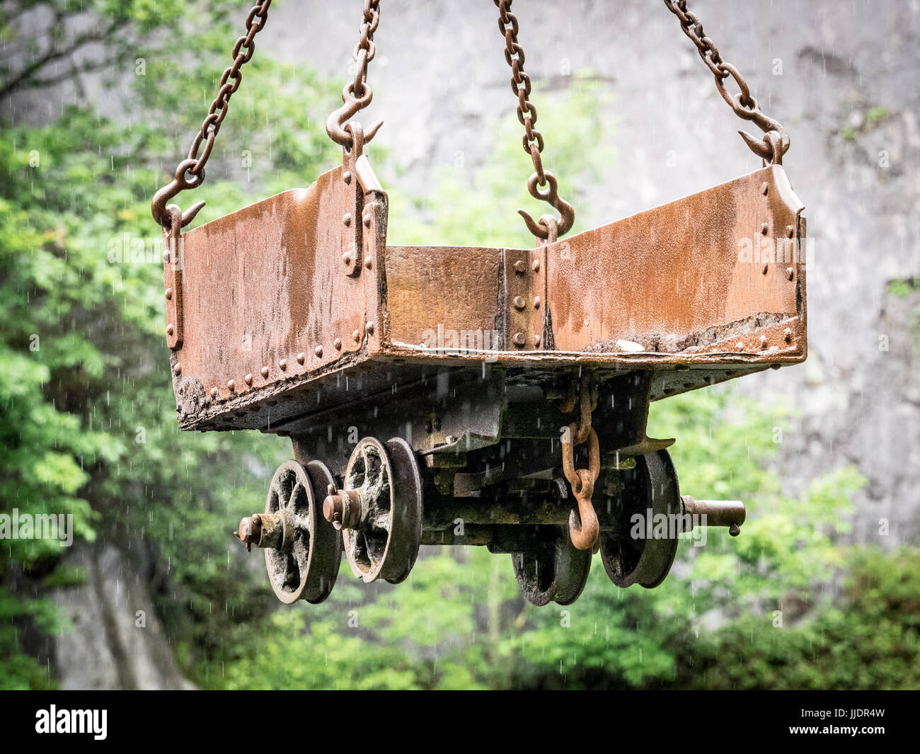 A slate truck suspended from an aerial tramway above Vivian Lake  Slate Quarry in North Wales Stock Photo