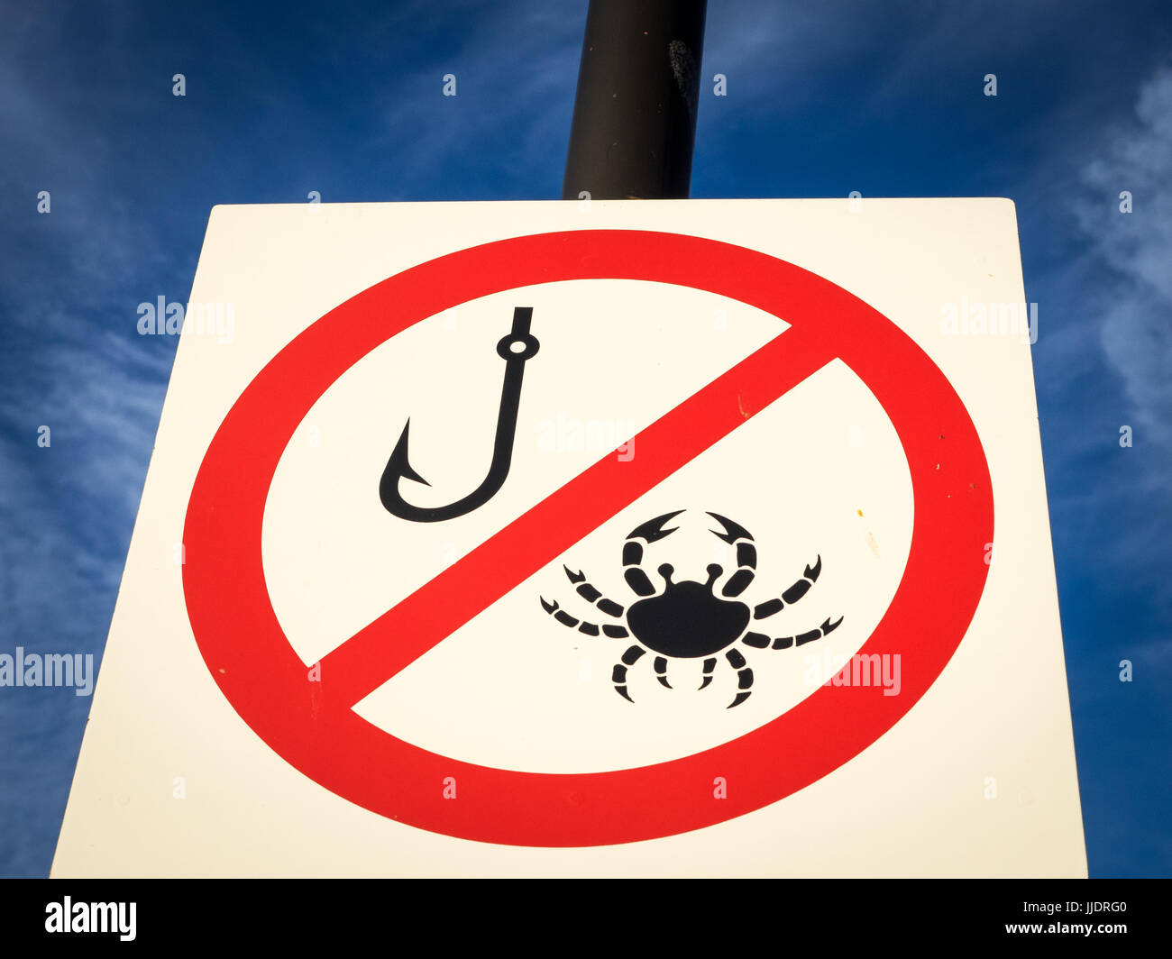 Crab Fishing Sign - Sign prohibiting crab fishing with fishing hooks in  North Wales Stock Photo - Alamy