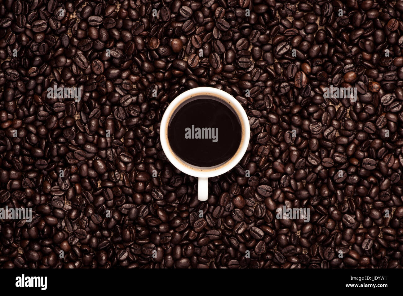 Coffee cup top view on roasted coffee beans background Stock Photo - Alamy