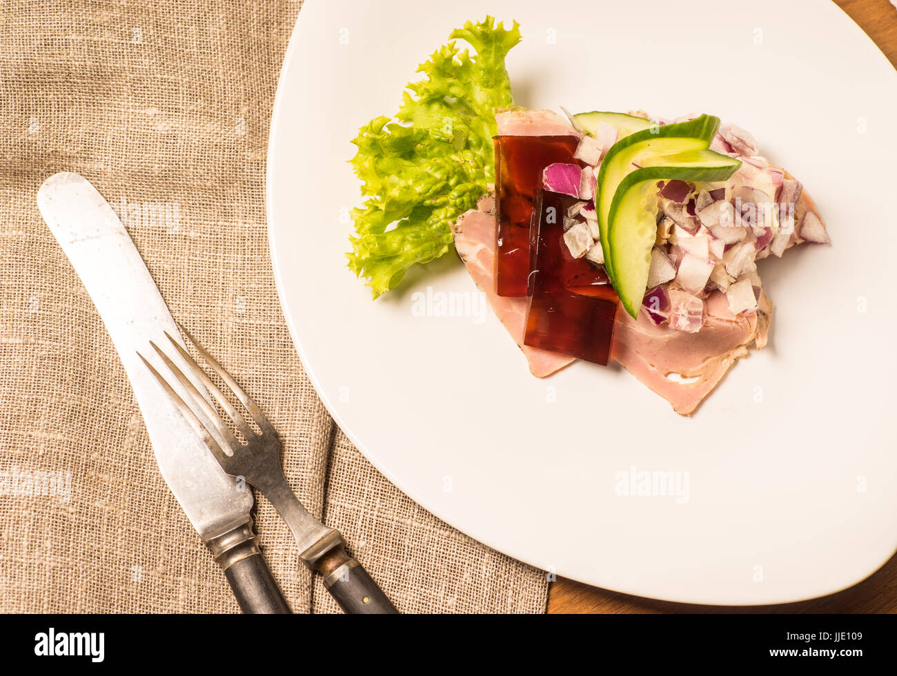 Danish specialties and national dishes, high-quality open sandwich. Sandwich with pork roll sausage, rullepoelse, , jelly and raw red onions, served o Stock Photo