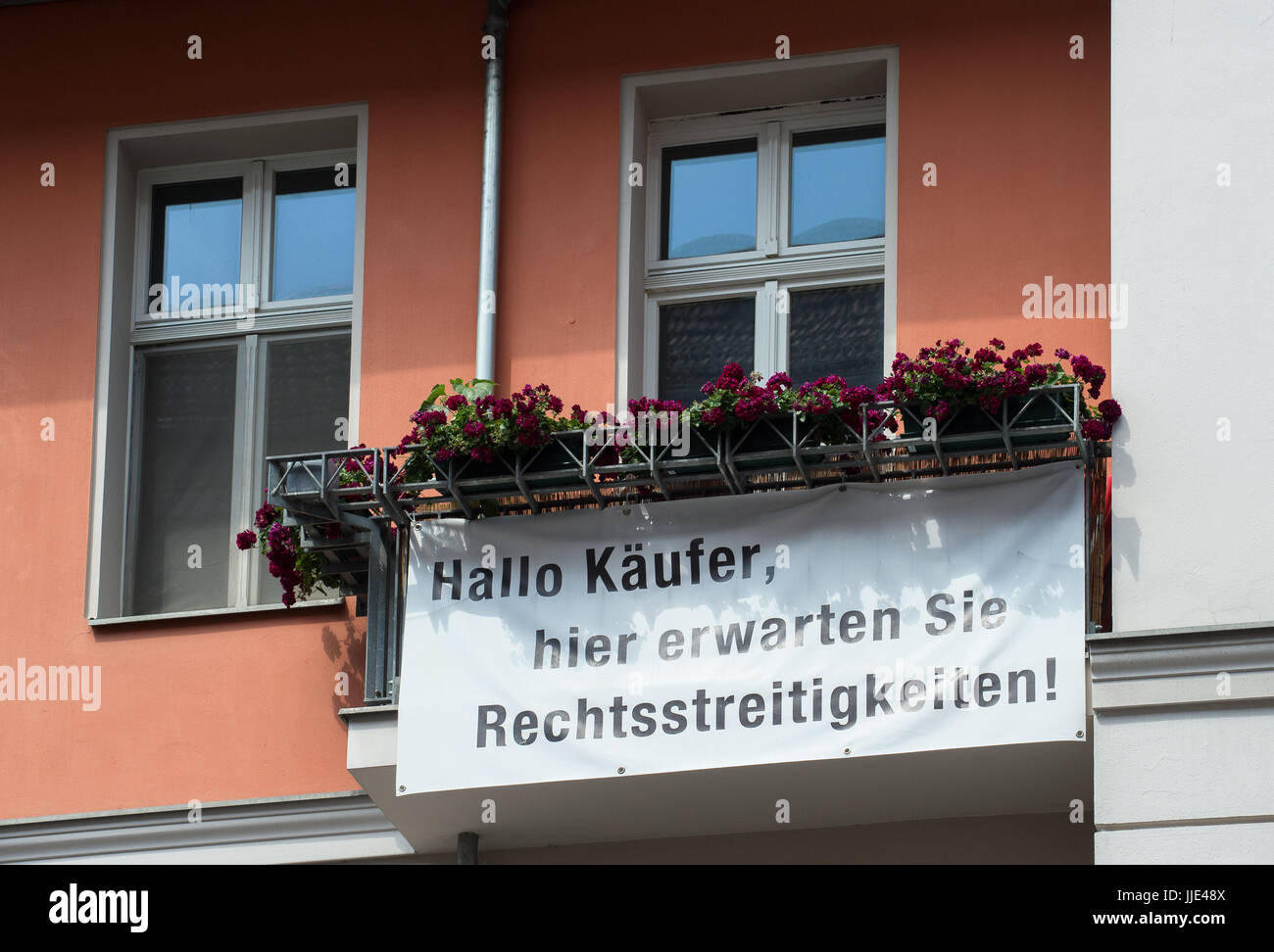 Berlin, Germany, sign on a house facade warns buyers of disputes Stock Photo