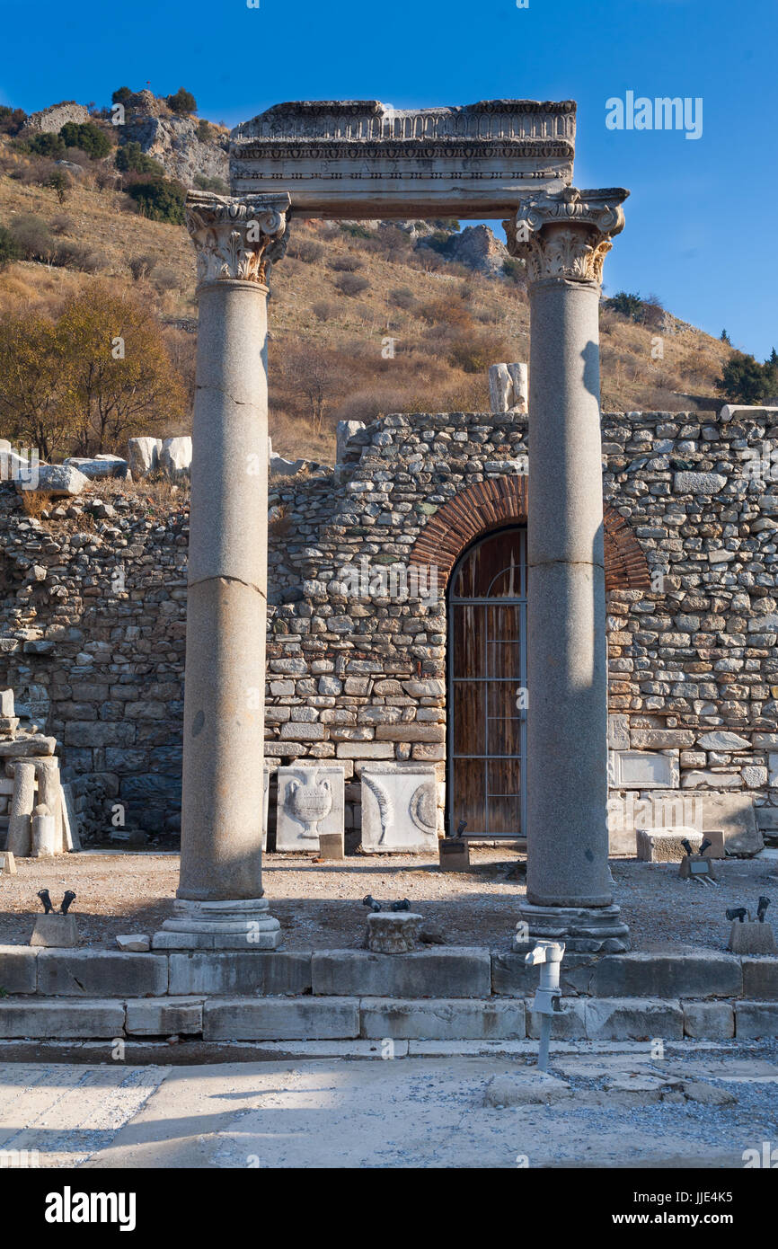 Classic White Roman Pillars at fallen Temple Door with statue decorated stone in ephesus Archaeological site in turkey Stock Photo