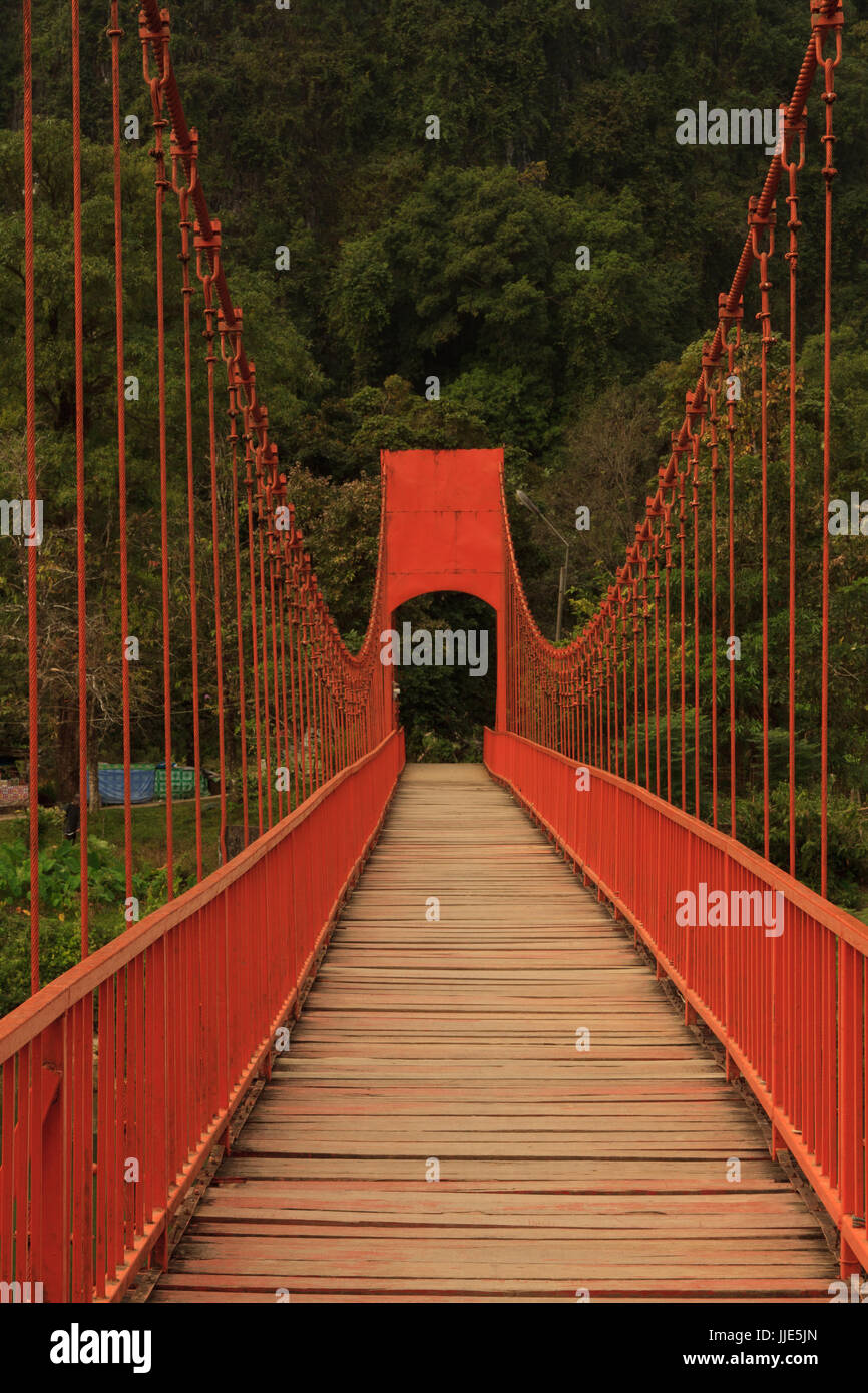 Red lead painted toll suspension footbridge Stock Photo