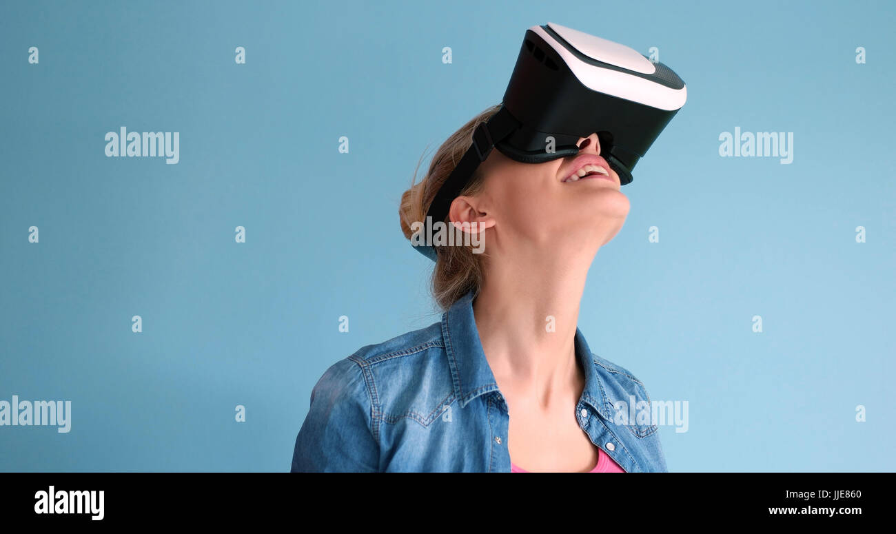 Happy girl getting experience using VR headset glasses of virtual ...