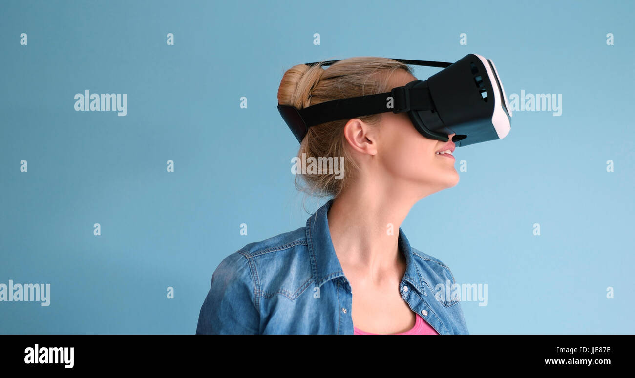 Happy girl getting experience using VR headset glasses of virtual ...