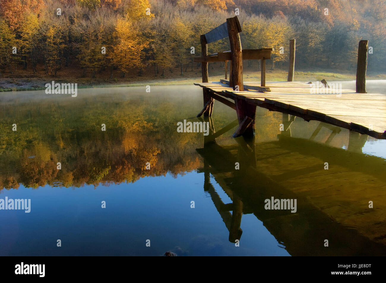 autumn morning landscape with lake and wooden jetty Stock Photo