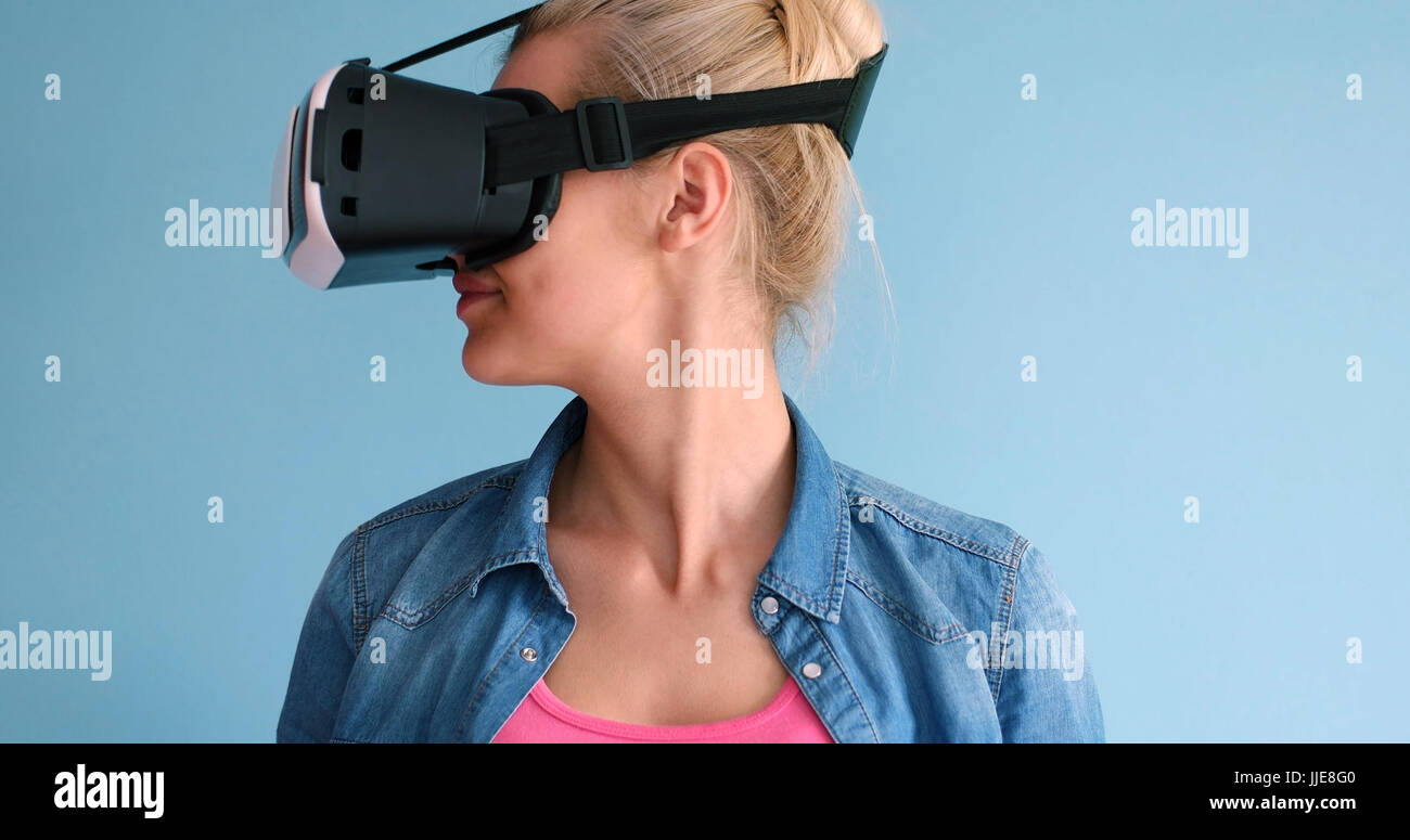 Happy girl getting experience using VR headset glasses of virtual ...