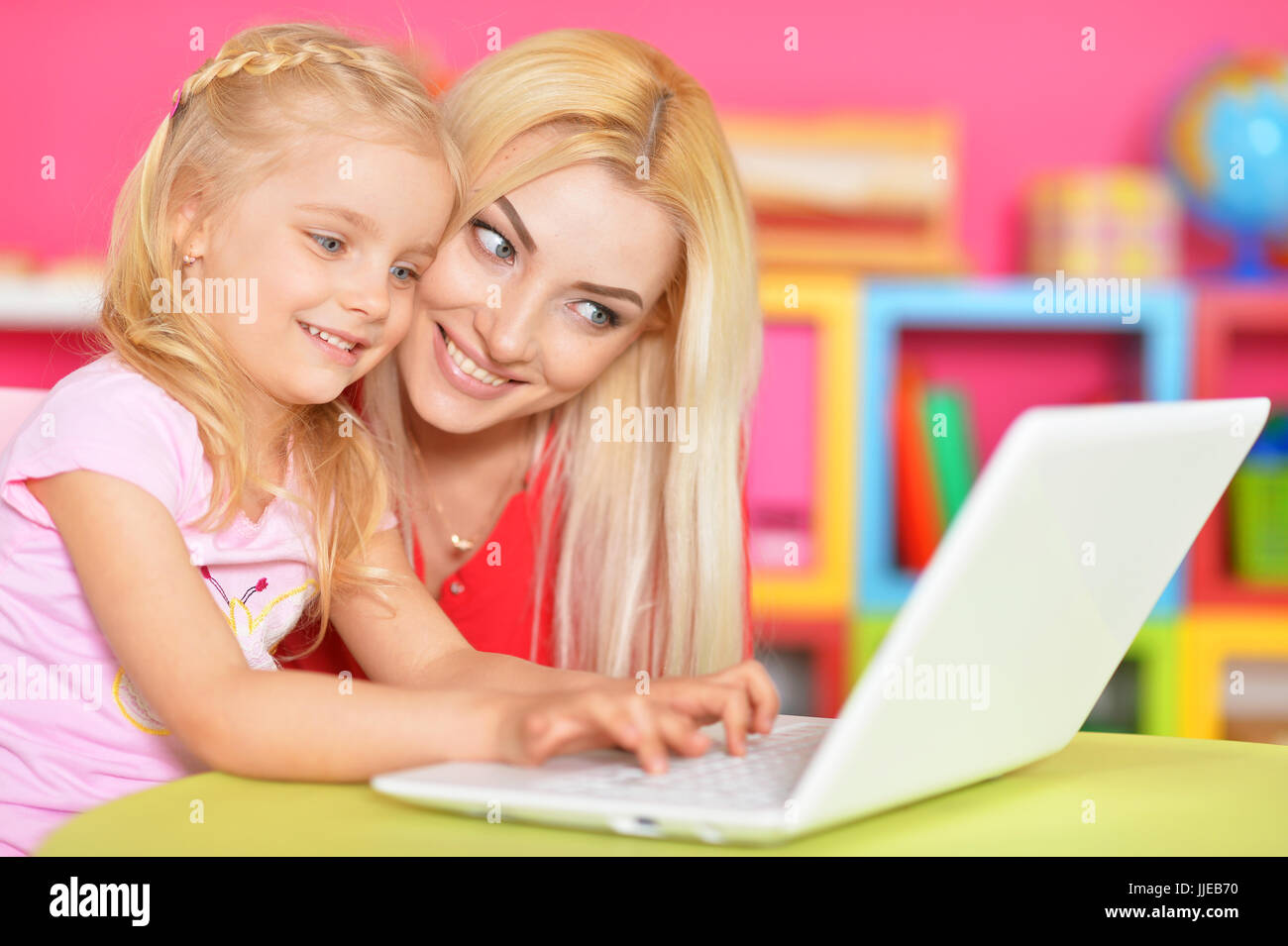 woman and little girl using laptop Stock Photo - Alamy