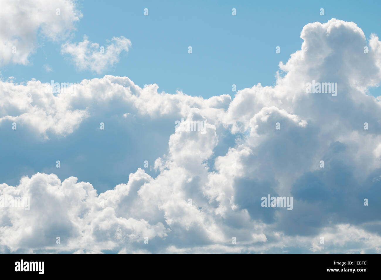 A blue sky with beautiful large fluffy clouds on a sunny and clear day ...