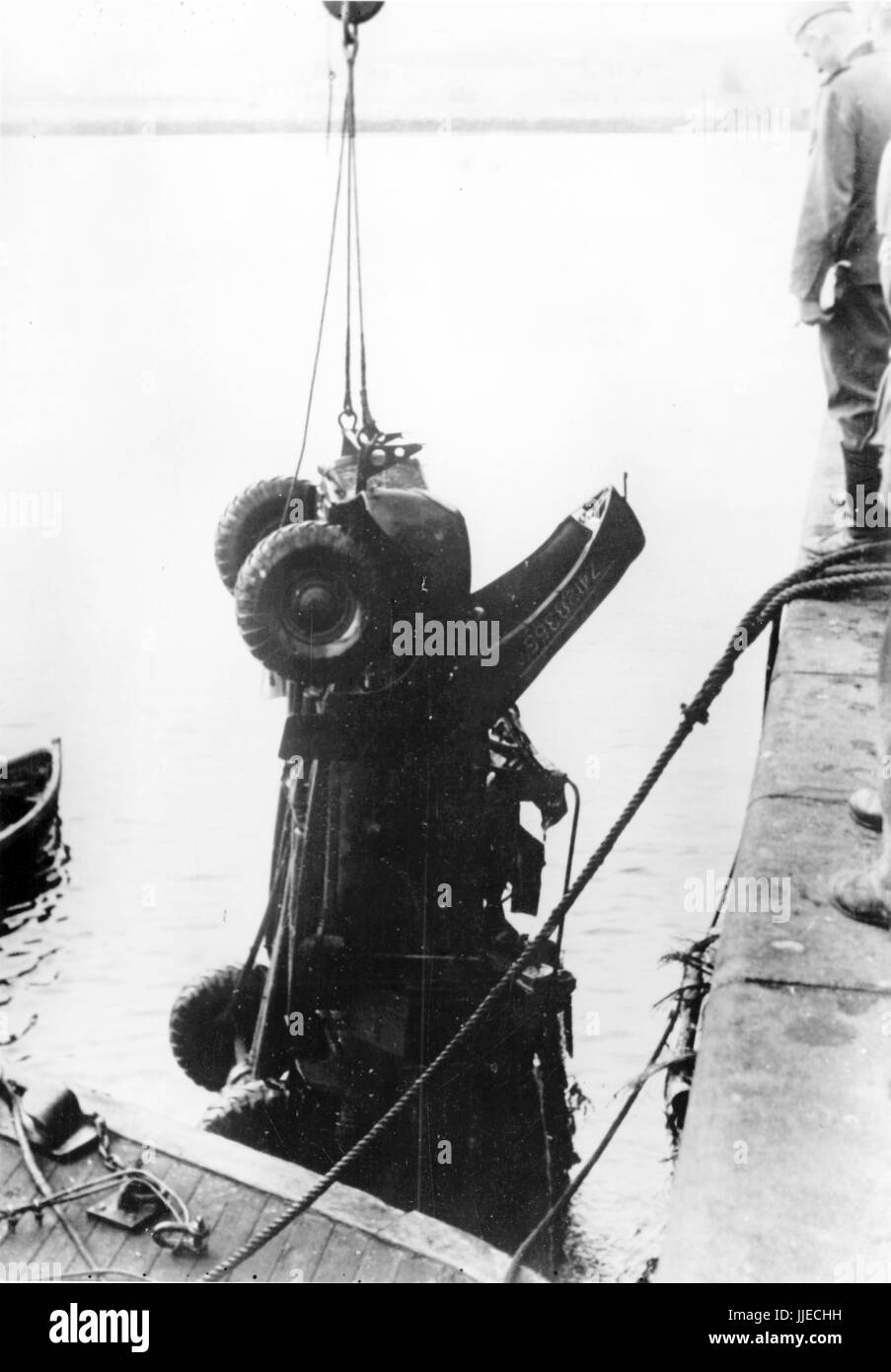 The Nazi propaganda image shows the salvaging of a British military vehicle in French Dunkirk (Dunkerque) after the British pulled out and German Wehrmacht troops occupied the town. Published in August 1940. A Nazi state reporter has written on the reverse of the image on 07.08.1940: 'The big clean-up. The vehicle, sunk in the French harbour during the 'glorious' retreat of the English troops, will now be restored by French dockworkers under German supervision.' Fotoarchiv für Zeitgeschichte - NO WIRE SERVICE - | usage worldwide Stock Photo