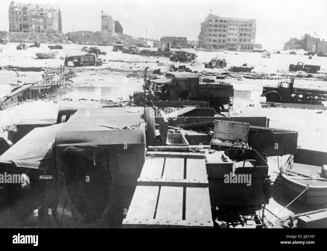 The Nazi propaganda image shows a destroyed British military plane and buildings on the riverbank of the Belgian town of De Panne near the French town of Dunkirk after the British evacuation and the German occupation. Published in June 1940. A Nazi state reporter has written on the reverse of the picture on 08.06.1940, 'In the chaos of Dunkirk. In La Panne near Dunkirk the English drove their vans into the sea to build an artificial bridge. During their desperate attempts, they were surprised by our pilots.' Fotoarchiv für Zeitgeschichte - NO WIRE SERVICE - | usage worldwide Stock Photo