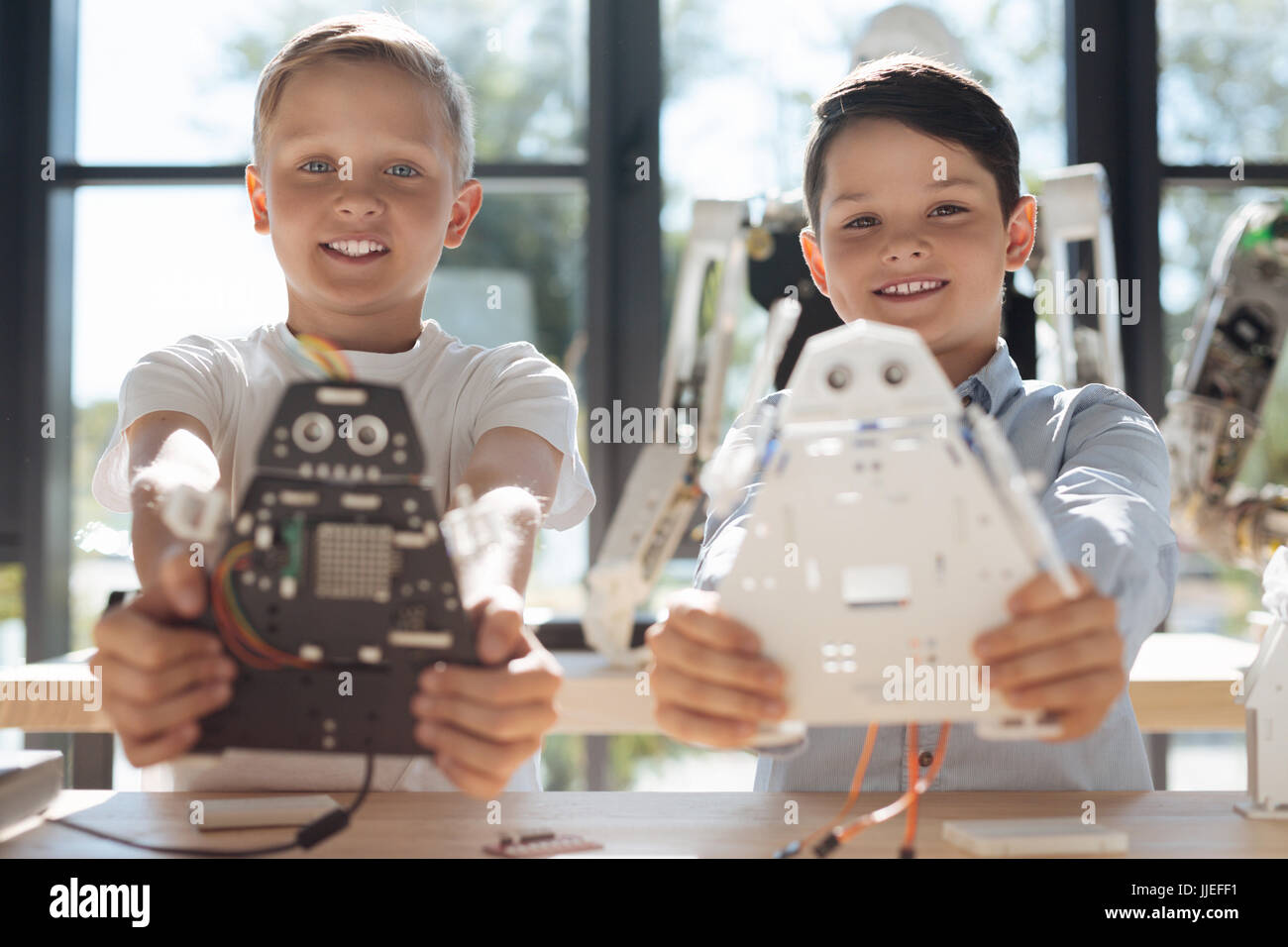 Upbeat boys demonstrating their robotic creations Stock Photo - Alamy