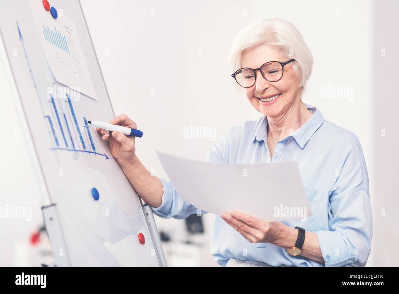 Woman Using Comparator Dedicated clever woman comparing diagrams Stock Photo - Alamy