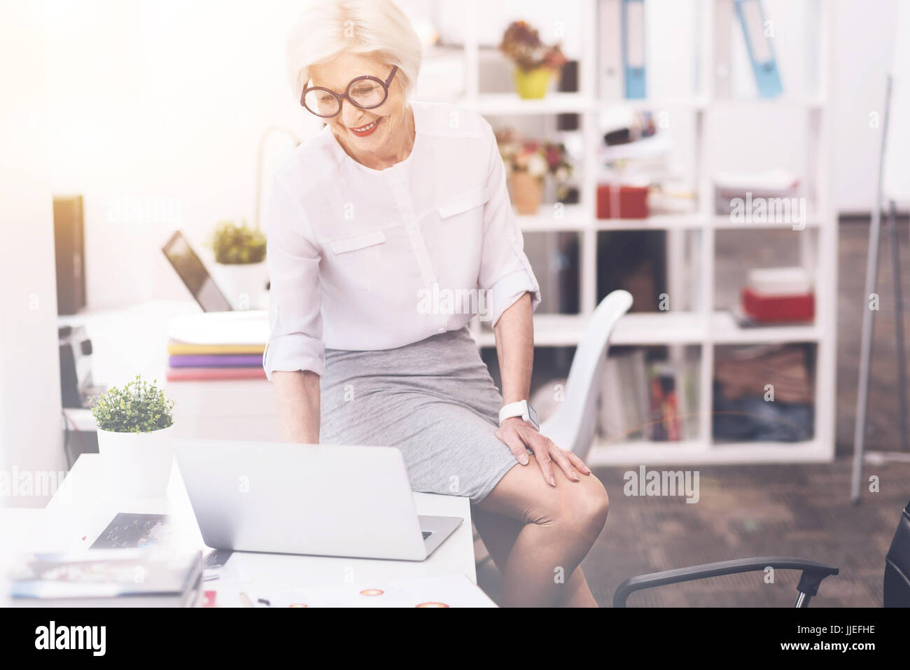 Active tech savvy lady looking through the mail Stock Photo