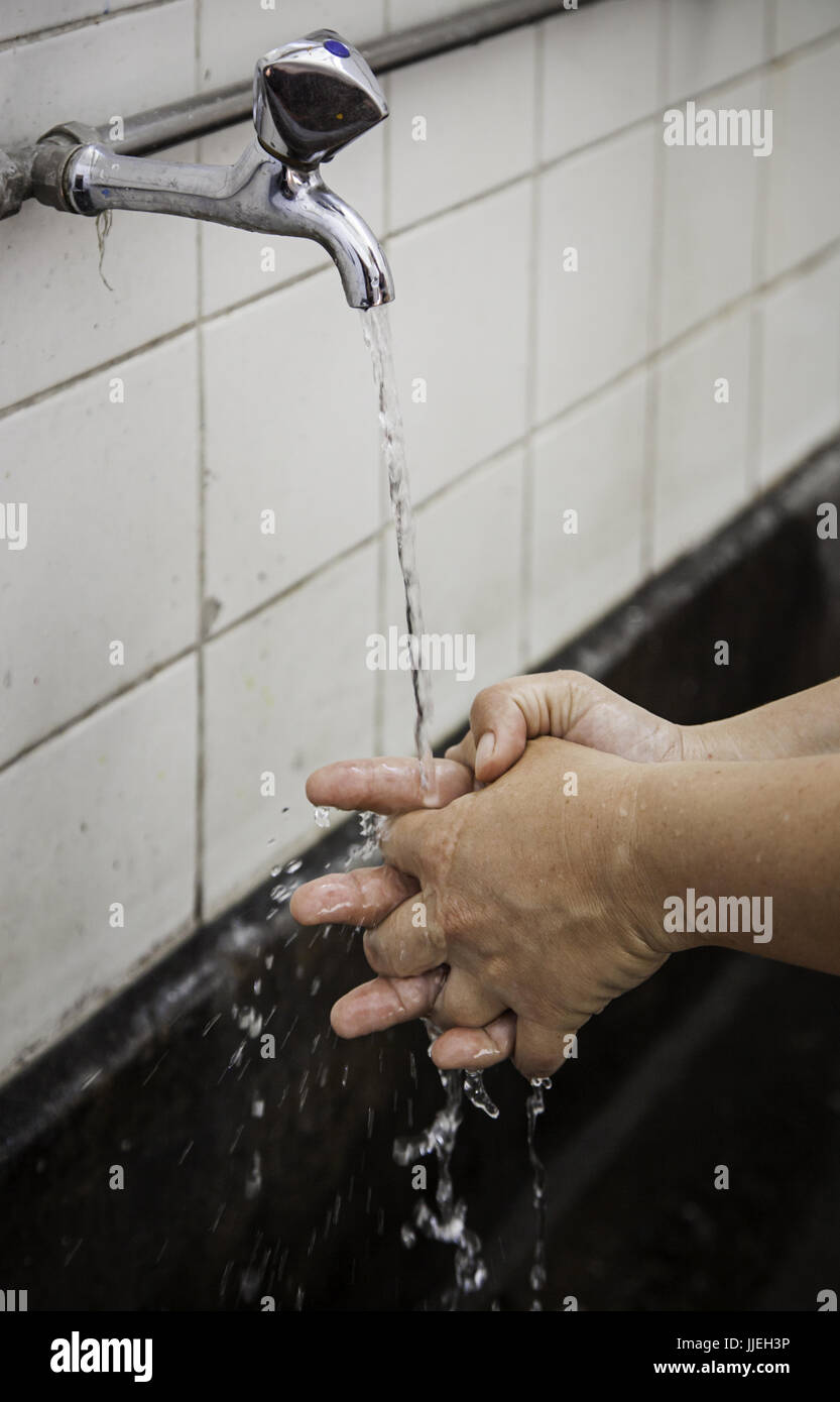 Young person washing their hands, hygiene and cleaning detail Stock