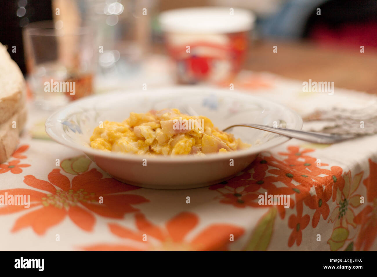 Scrambled eggs and bacon in ceramic dish with fork an Italian Food Made in Italy with Flower