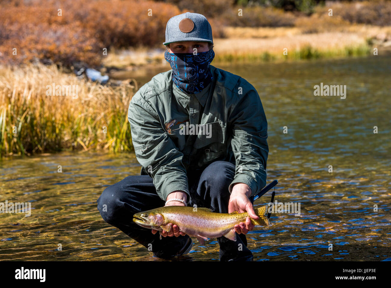 Tim with a Lahontan Cutthroat trout at a secret eastern sierra lake Stock Photo