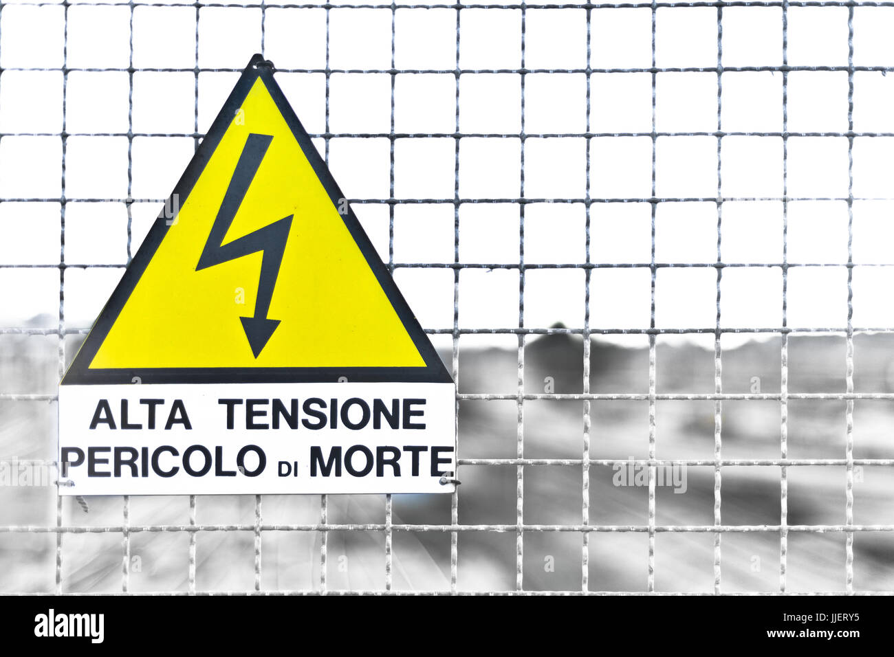 Italian Text on Triangle Yellow Metal sign and text means 'High Voltage, Danger of Death' Stock Photo