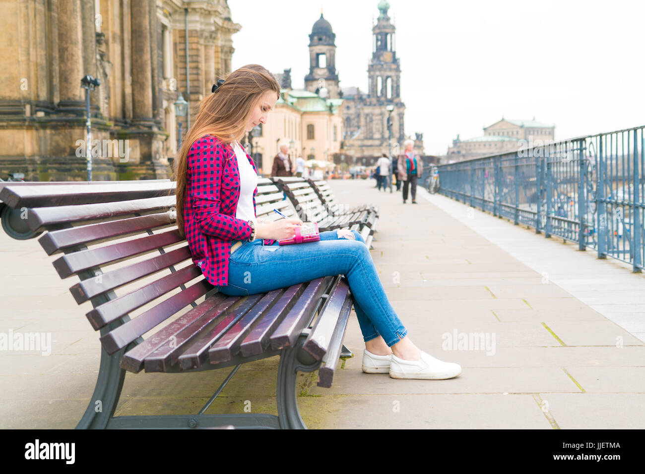 girl writes in the diary the impression of the tourist on Dresden Stock Photo