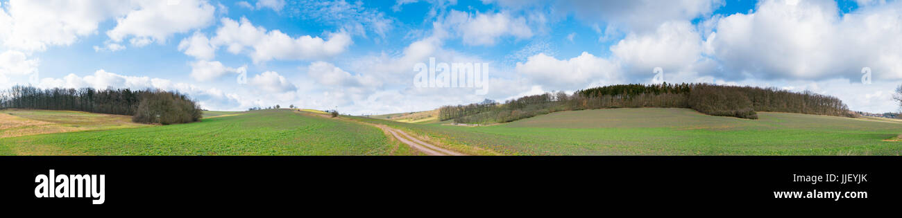 Panorama of green field and blue sky with clouds Stock Photo - Alamy
