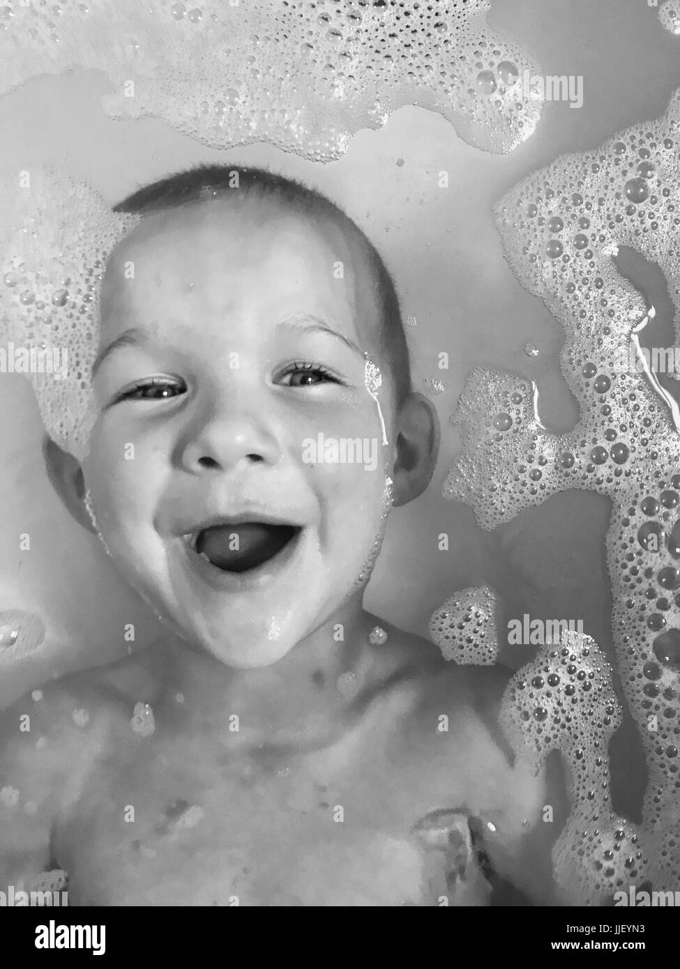 Laughing boy in the bath Stock Photo