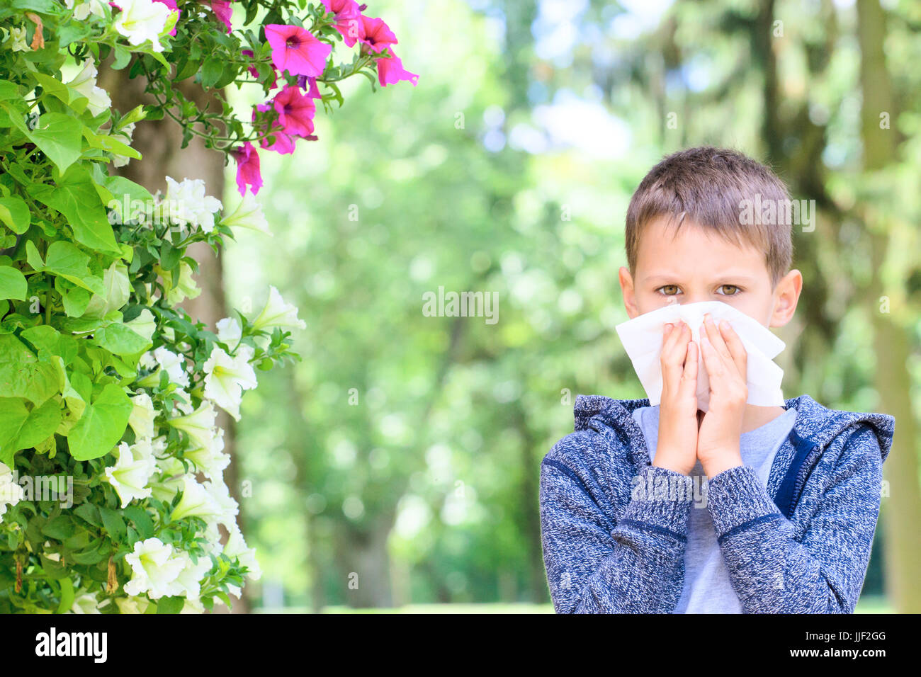 Allergy. Little boy has allergies from flower pollen Stock Photo - Alamy