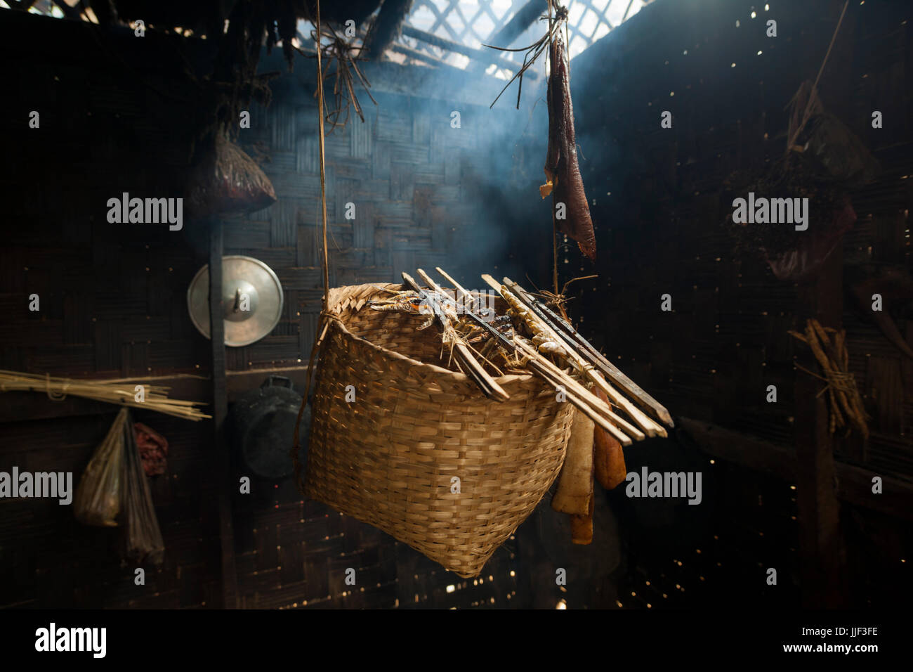 Fish and meat are smoked and dried above a fire at a home in Ban Huay Phouk, Laos. Stock Photo