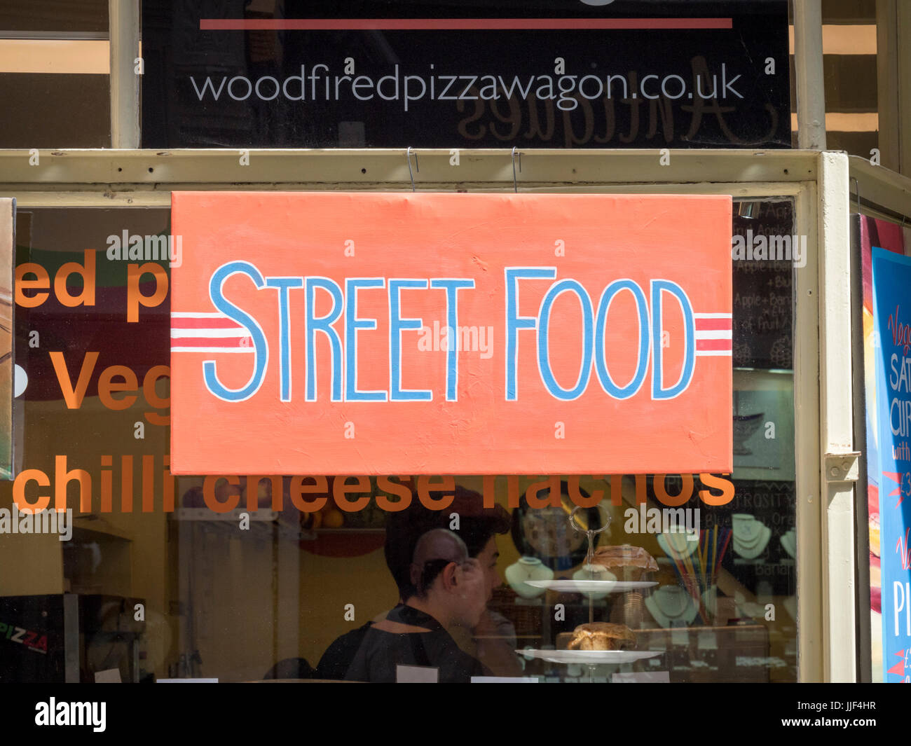 A sign for street food in a cafe window in Norwich Norfolk UK Stock Photo