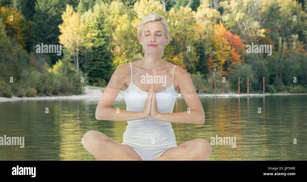 Digital composite of Woman doing yoga in front of a lake and wood Stock ...