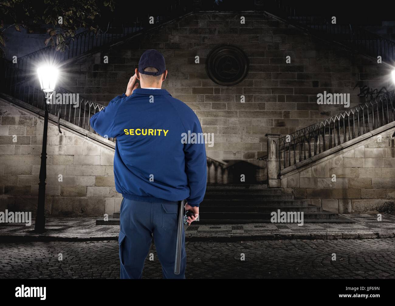 Digital composite of security guard guarding the park at night Stock Photo