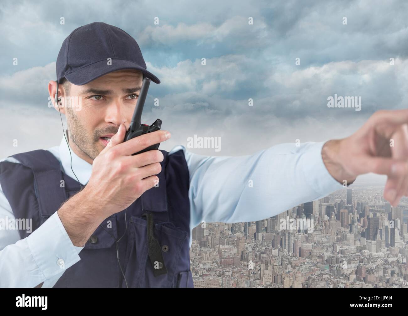 Digital composite of Security guard with walkie talkie pointing against skyline and clouds Stock Photo