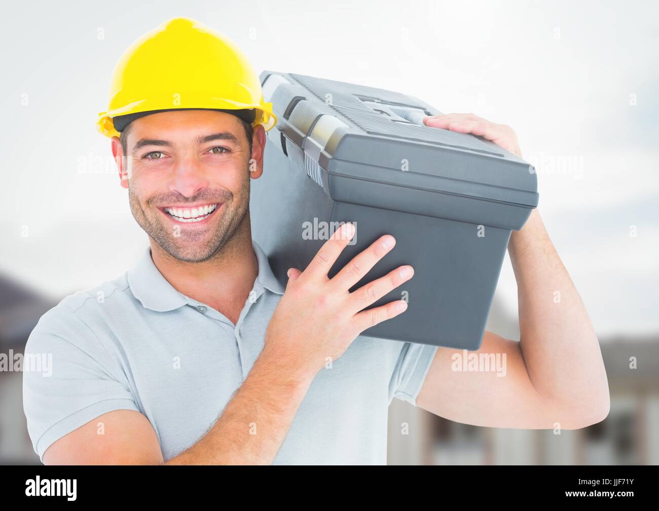 Digital composite of Construction Worker with tool box in front of