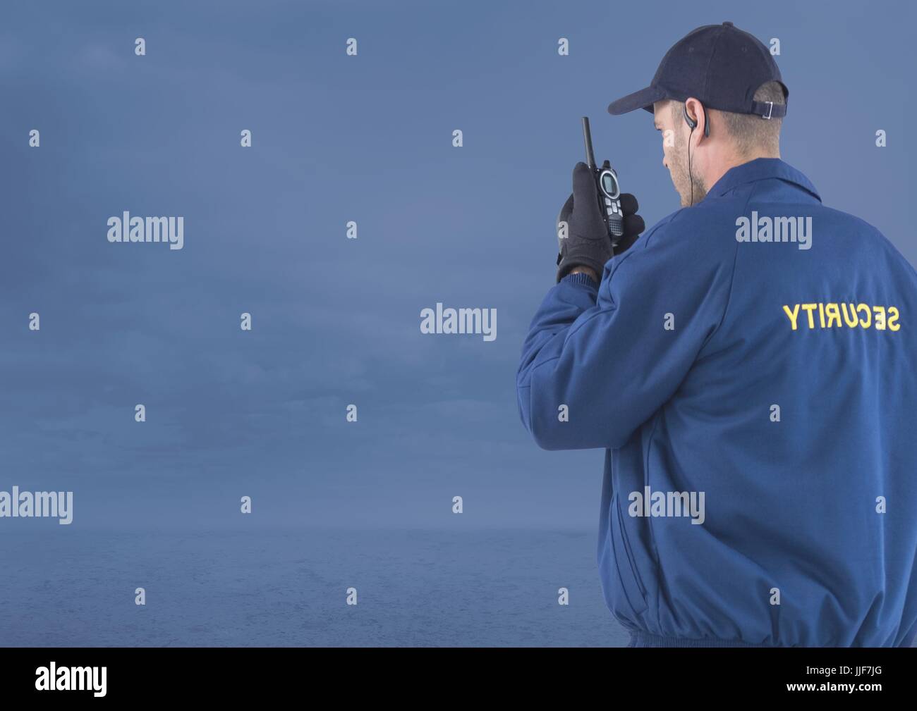 Digital composite of Security man outside with blue background clouds Stock Photo