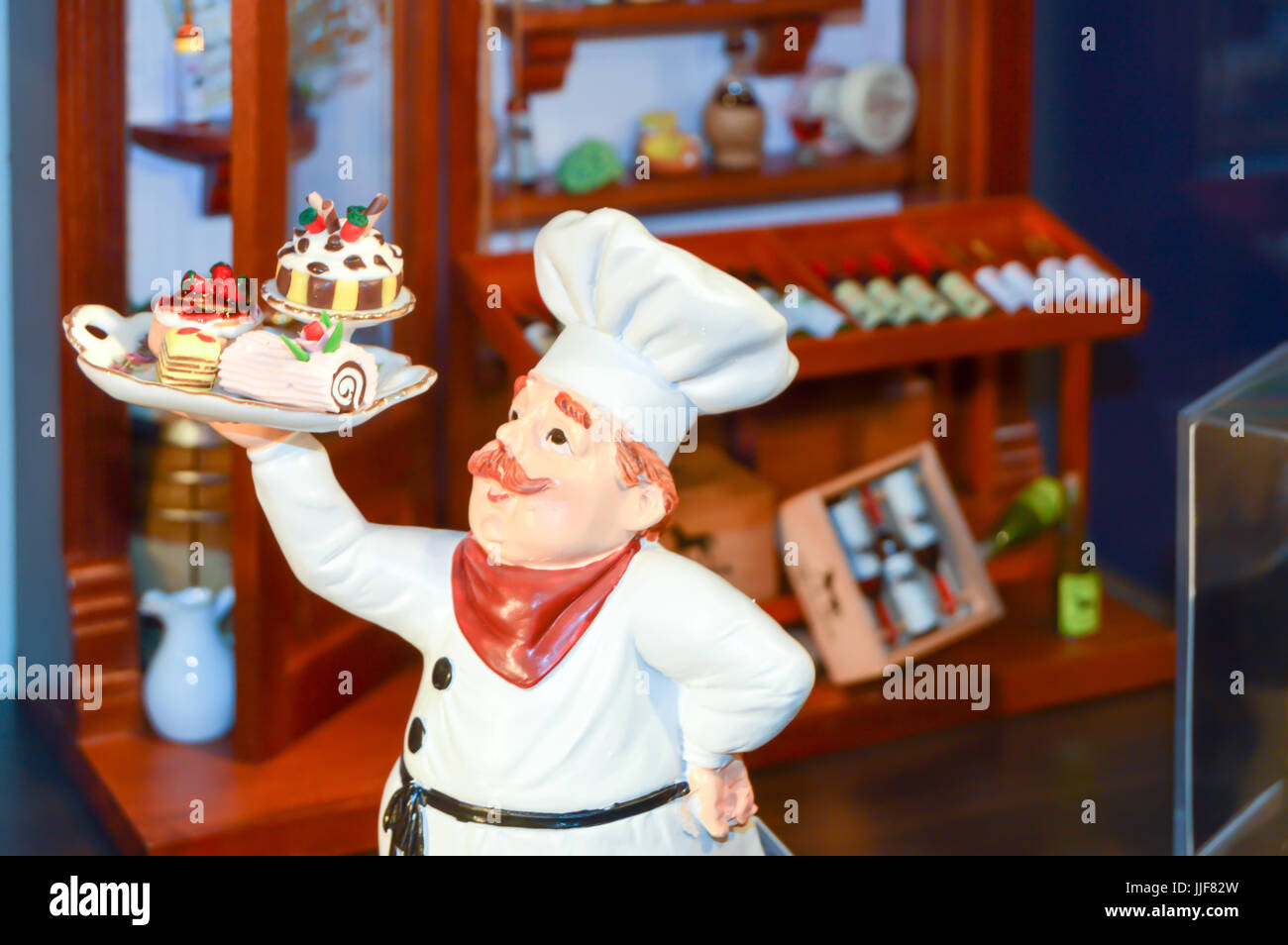 Effigy of a chief cook carrying a tray of cakes in a restaurant in black forest Stock Photo