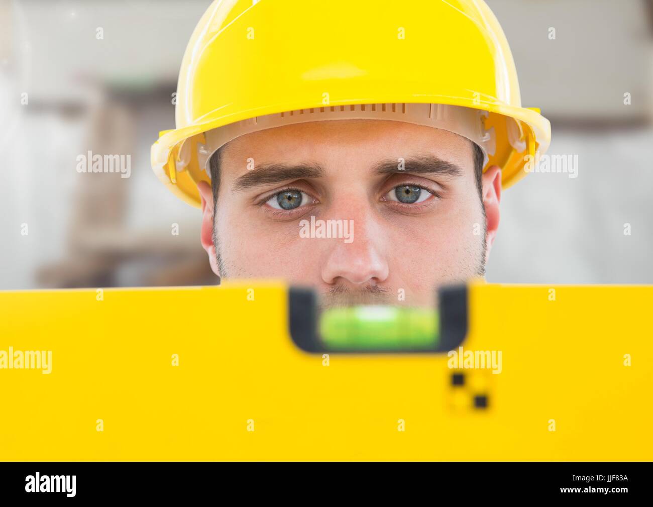 Digital Composite Of Construction Worker With Spirit Level In Front Of