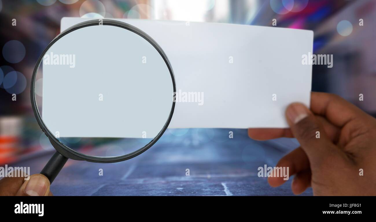 Digital composite of magnifying glass looking at paper on street Stock Photo