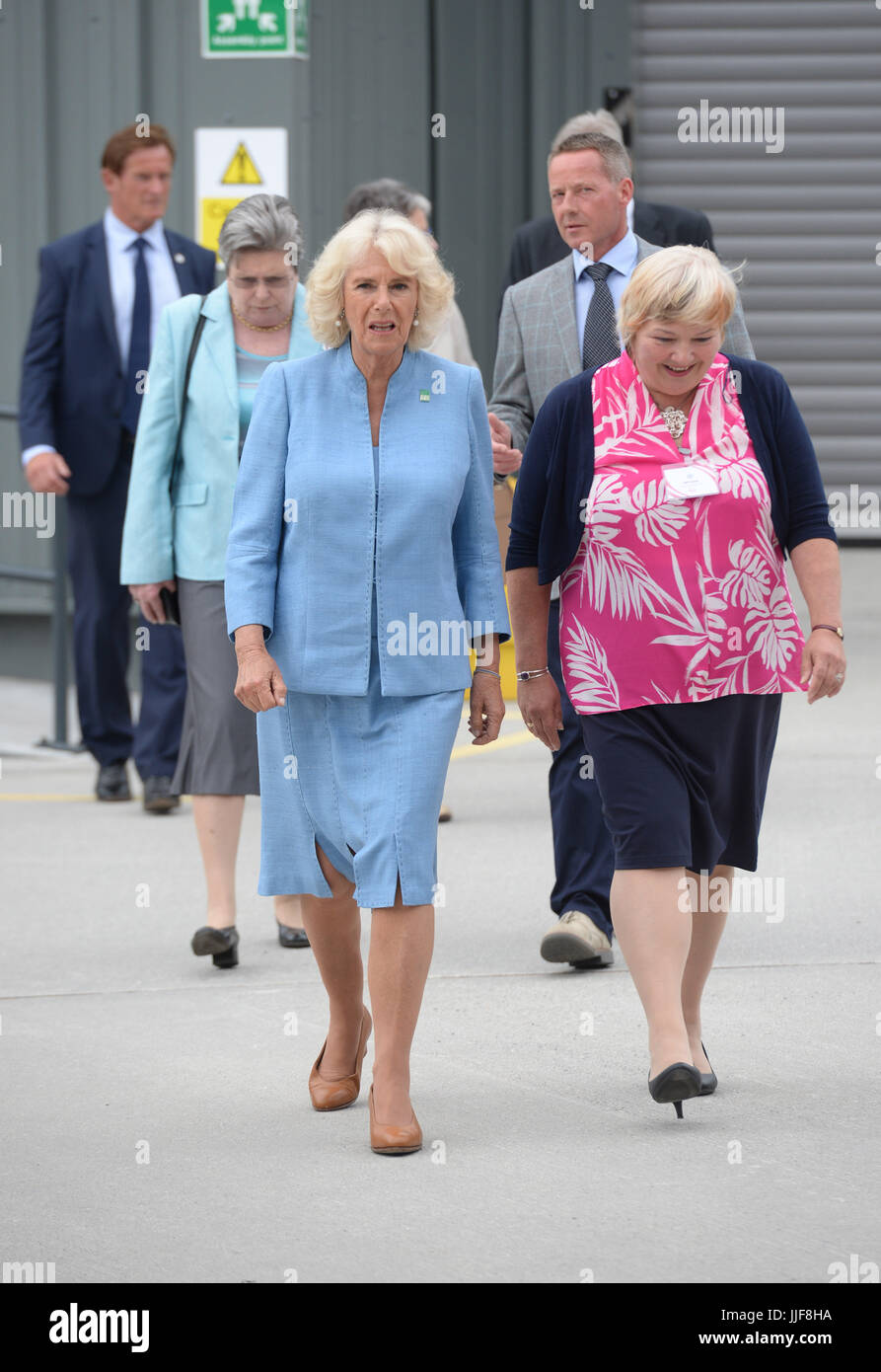 The Duchess of Cornwall (front left) with commercial director Bev Bird, during a visit to Caterlink, in Bodmin, a Cornish business specialising in ice cream cones, toppings, decorations and accessories. Stock Photo
