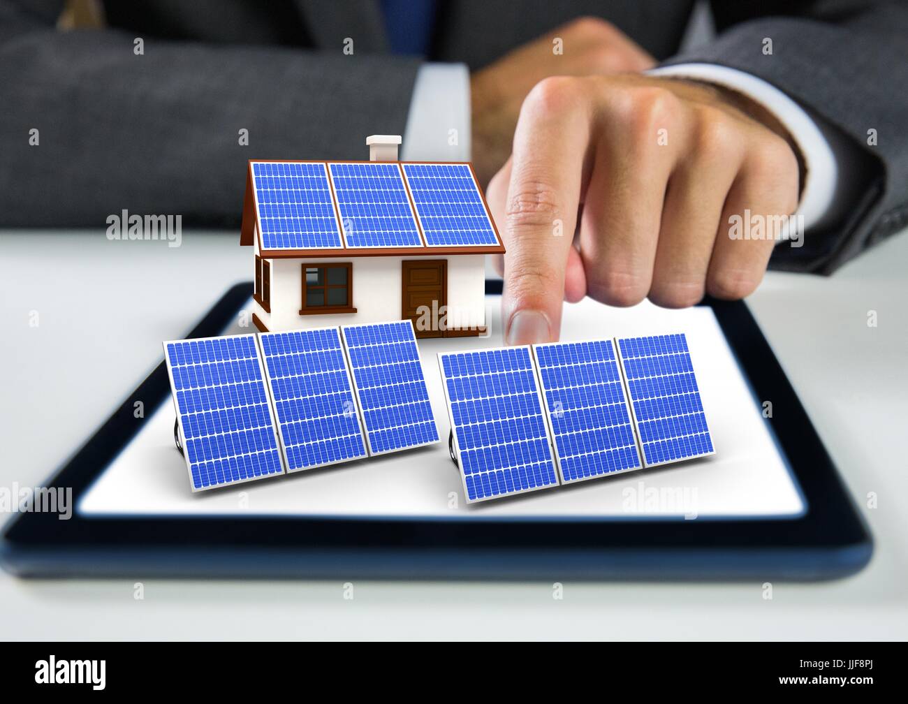 Tablet Using Solar Panel Digital composite of solar panel and house with solar panel on tablet ...