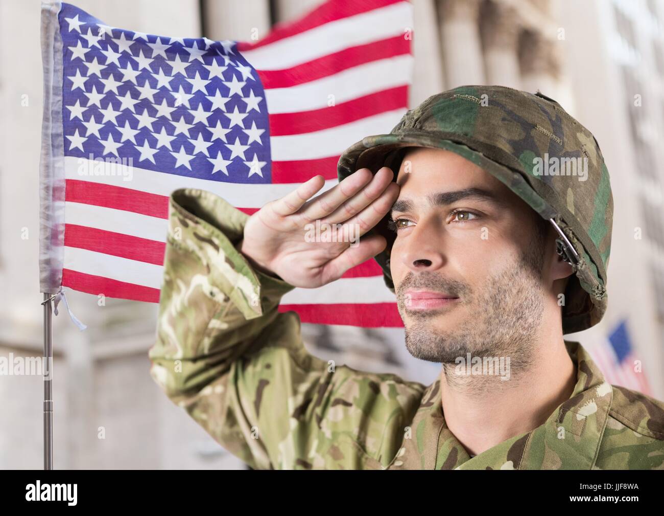 Digital composite of soldier in front of building with usa flag behind ...