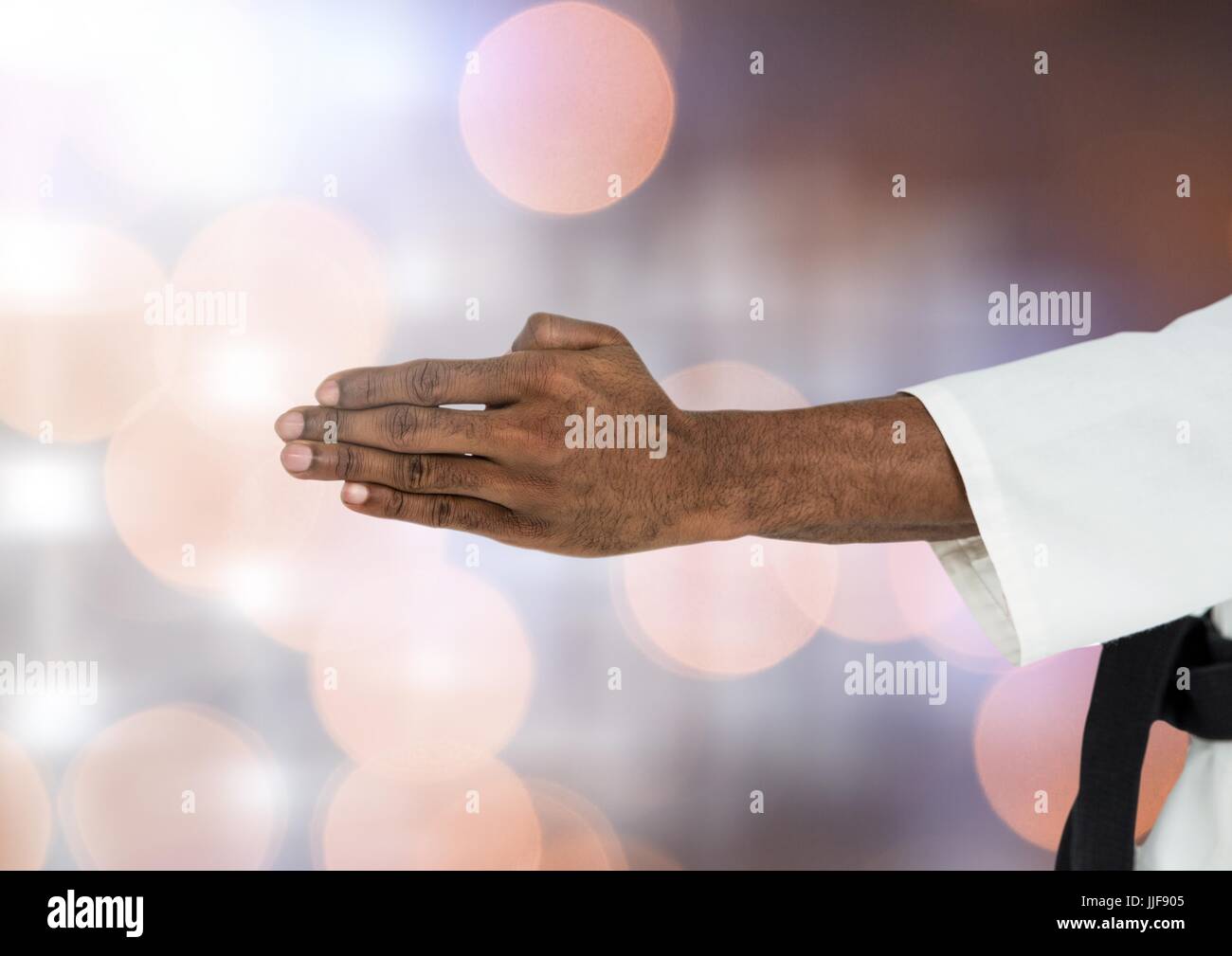 Digital composite of Martial Arts mans' Hands together with sparkling