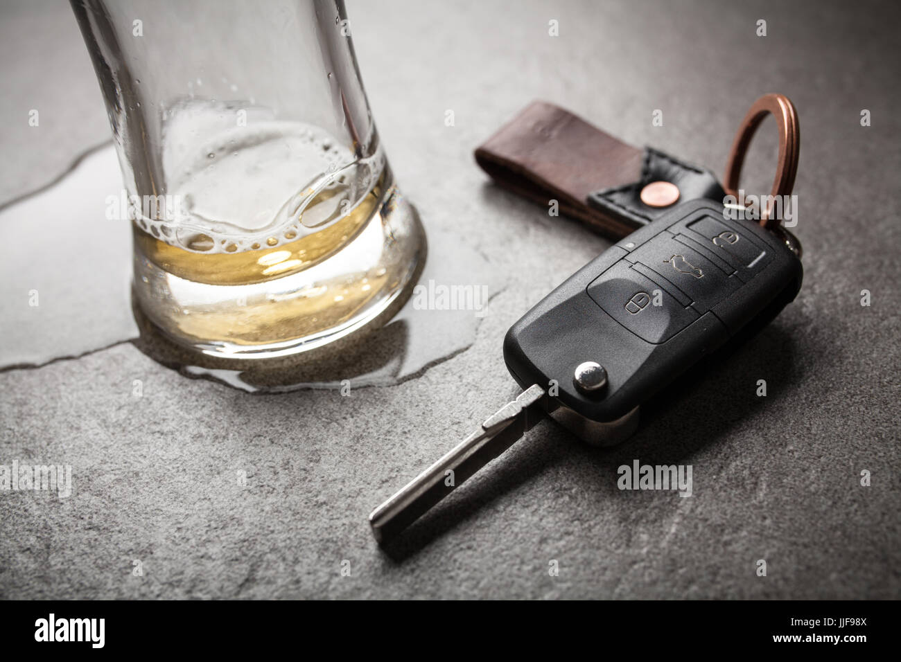 Drunk driving concept spilled beer and car keys on a table Stock