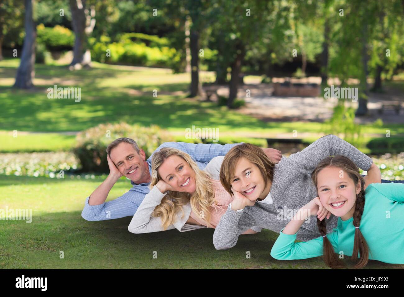 Digital composite of Happy family laying on the grass Stock Photo - Alamy